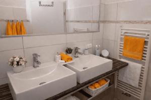 a bathroom with a white sink and a mirror at Ferienwohnungen Gutenbrunn in Gutenbrunn +12 photos