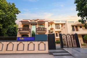 a building with a gate in front of it at FabHotel The Arjun Sushant lok - Iffco Chowk Sector 29 in Gurgaon
