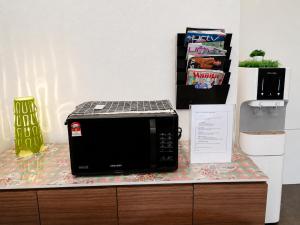 a microwave sitting on top of a counter at The Leverage Business Hotel - Rawang in Rawang