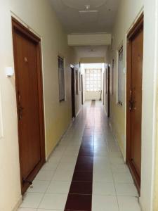 a hallway of a building with a long corridor at Om Sai Manjunatha Residency in Puttaparthi