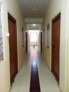 a hallway of a building with a long corridor at Om Sai Manjunatha Residency in Puttaparthi +1 photo