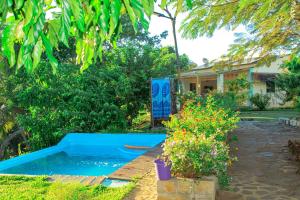 a blue pool in the yard of a house at Villa HARMONY in Andilana