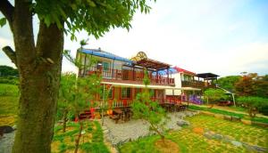 a large house with a large yard in front of it at Namusori pension in Koesan +22 photos