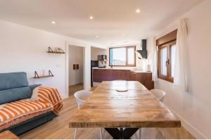 a living room with a wooden table and a couch at EL RINCÓN DE DENVER in Suances