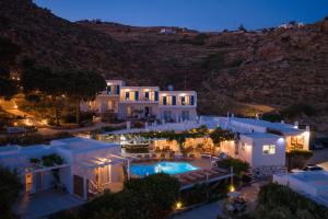 an aerial view of a house with a pool at night at Rhenia Mykonos Hotel & Bungalows in Tourlos