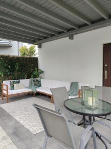 a patio with a glass table and chairs at Aparthotel Cieplice in Jelenia Góra