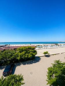 a view of a beach with a car on the sand at Dostar Beach Hotel - Достар Жағажай Қонақүйі in Aktau