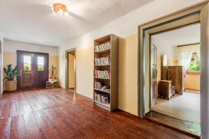 an empty living room with a book shelf at Holiday house Pod Ledinco in Most na Soči