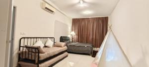 a living room with a bed and a bedroom at Bouncing Fun House in Medini in Iskandar Puteri