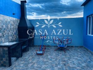 a room with chairs and a sign that reads casa azul hostel at Casa Azul in La Quiaca