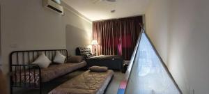 a living room with a bed and a couch at Bouncing Fun House in Medini in Iskandar Puteri