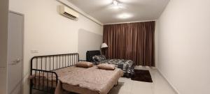 a bedroom with a bed with pillows on it at Bouncing Fun House in Medini in Iskandar Puteri