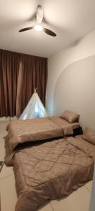 a bedroom with two beds and a ceiling fan at Bouncing Fun House in Medini in Iskandar Puteri +19 photos