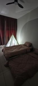 a bedroom with a bed with a lamp on it at Bouncing Fun House in Medini in Iskandar Puteri