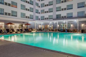 a large swimming pool in front of a building at Cambria Hotel Phoenix Chandler - Fashion Center in Chandler