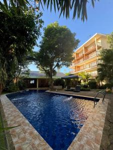 a swimming pool in front of a building at Boracay Amor Apartment in Boracay