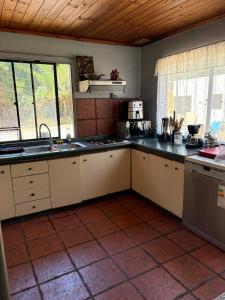a kitchen with a sink and a stove top oven at Habitación Suite in Chimbarongo