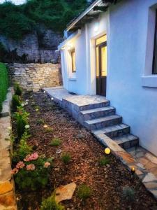 a house with a staircase next to a building at Charshiq Guest House in Veliko Tŭrnovo
