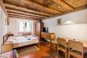 a bedroom with a bed and a desk and a table at Farmhouse Cvetje in Tolmin