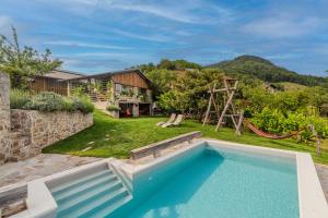 an image of a backyard with a pool and a playground at Farmhouse Cvetje in Tolmin