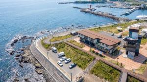 an aerial view of a building next to the water at Pohang Baritdol Pension in Pohang