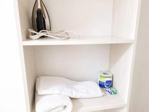a shelf with towels and a can of toothpaste at Annie's studio near Westside mall in Nakuru