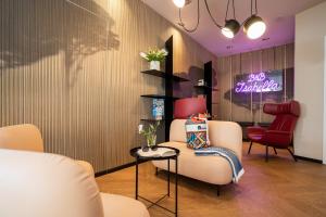 a salon with a white chair and a neon sign at B&B Isabella in Milano Marittima +104 photos