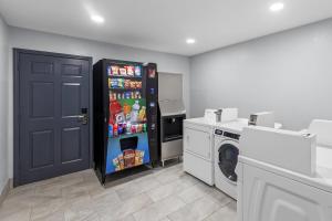 a kitchen with a refrigerator and a washing machine at Quality Inn Ponca City in Ponca City