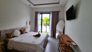 a bedroom with a bed and a surfboard in it at Sari Hills Bali in Nusa Dua +18 photos