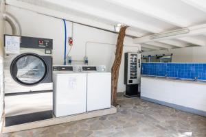 a laundry room with a washer and dryer at Camping Car Palmasera in Cala Gonone