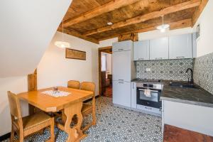 a kitchen and dining room with a wooden table at Farmhouse Cvetje in Tolmin
