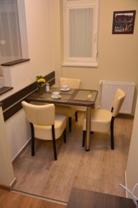 a dining room with a table and chairs at Bodza Apartmanok in Eger