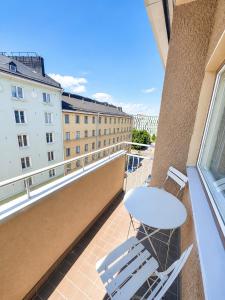 a balcony with a white chair and a window at City Home Kalliossa in Helsinki