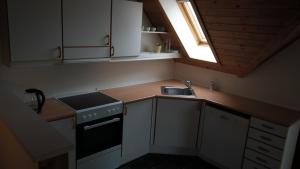 a small kitchen with a sink and a window at Central located Large apartment on the 1st floor tv in Hjørring +12 photos