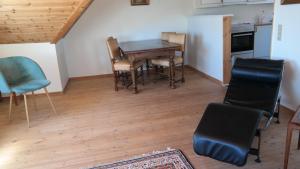 a kitchen and dining room with a table and chairs at Central located Large apartment on the 1st floor tv in Hjørring