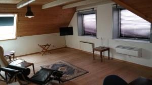 a living room with a couch chairs and a television at Central located Large apartment on the 1st floor tv in Hjørring