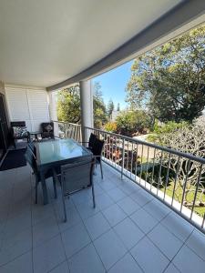 a balcony with a table and chairs on it at Jubilee Apartment 11 - Bring your own linen in South West Rocks