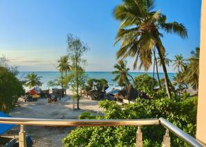 a view of the beach from the balcony of a resort at Aurora Nungwi in Nungwi