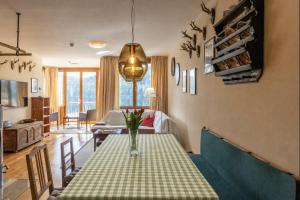 a living room with a table with a vase on it at Seeappartement Altaussee - Your Austrian Home in Altaussee