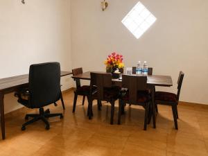 a dining room with a wooden table and chairs at Sattvic Ceylon- Wellness Homestay in Colombo +21 photos