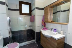 a bathroom with a sink and a shower at Lina's House in Syvota +12 photos