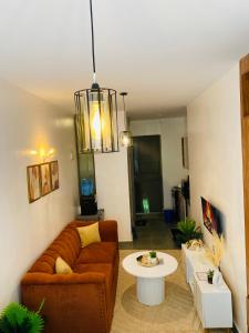a living room with a couch and a table at Nomads nest suites in Kiambu