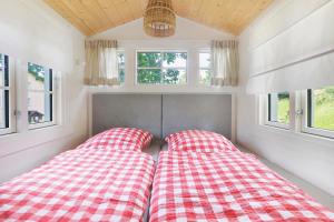 two beds in a small room with windows at Waldwagen Altes Forstamt Sinntal in Sinntal
