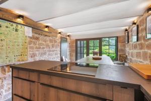 a kitchen with a large island in a room at Waldwagen Altes Forstamt Sinntal in Sinntal