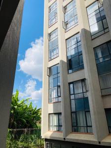 a tall building with windows on the side at Nomads nest suites in Kiambu
