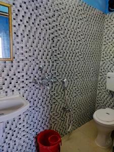a bathroom with a shower and a toilet and a sink at Priya guest house in Howrah