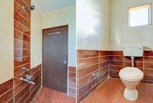 a bathroom with a toilet and a shower at Priya guest house in Howrah