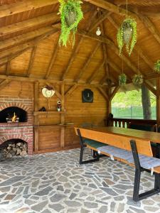 a wooden room with a bench and a fireplace at Casa Bucuriei - Plaiul Foii, Zărnești in Zărneşti