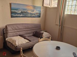 a living room with a couch and a table at Studio centre ville d'orange in Orange