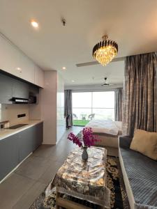 a living room with a bed and a table at Luxurystay-supernova in New Delhi